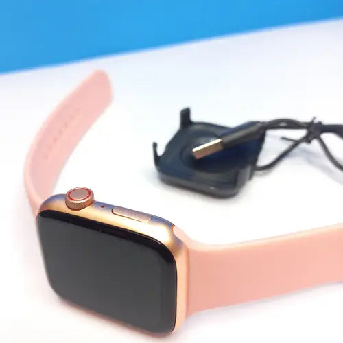 a gold i8 Pro Max smart watch with a pink band and a black display showing the time.