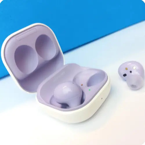 Samsung Galaxy Buds 2 earphones in purple color, placed inside their charging case.