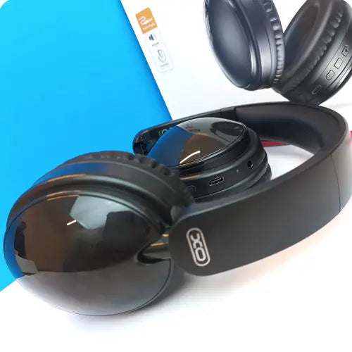 A pair of XO BE36 Portable Wireless Bluetooth Headphones in black color, displayed alongside its packaging.